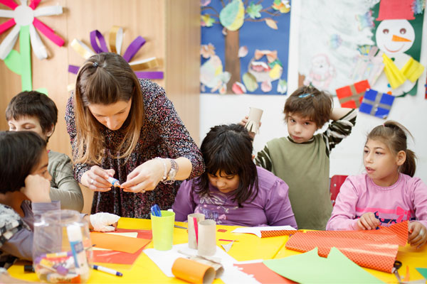 woman teaching disabled preschool children